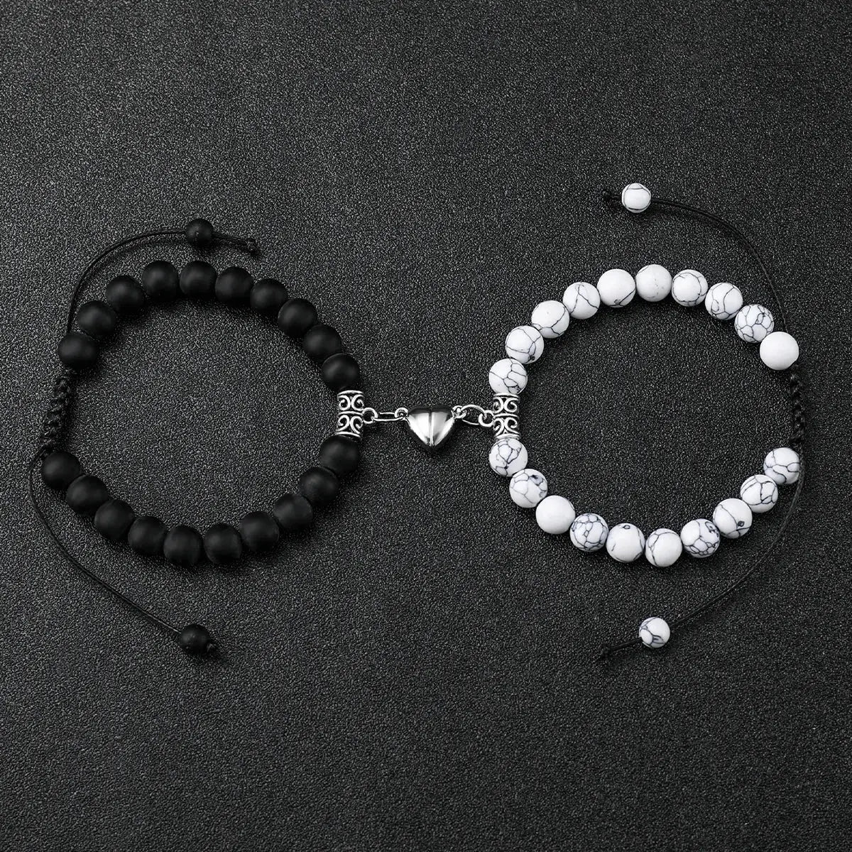 Geneva couple bracelet set: two bracelets, black matte bead and white marble bead, linked by a silver heart clasp