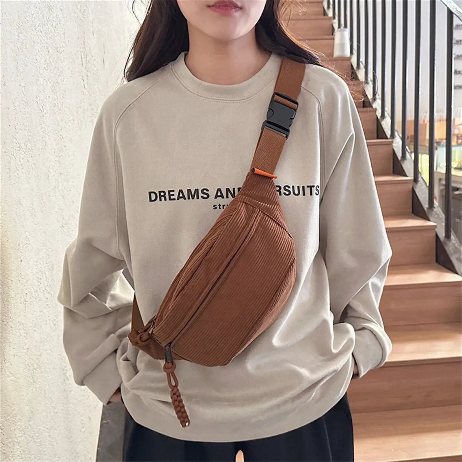 Simples Market brown corduroy belt bag worn crossbody by a woman