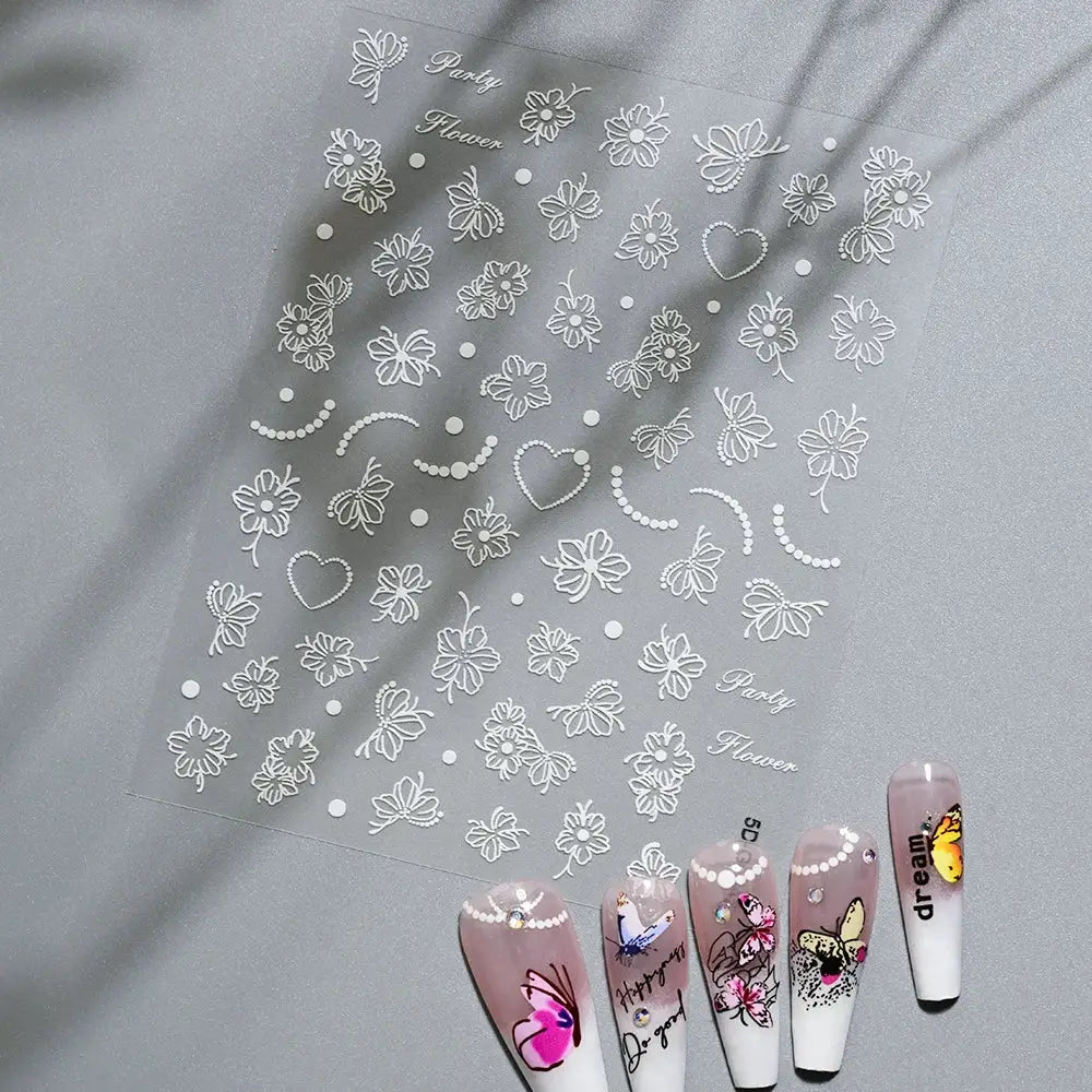 Nail art sticker sheet with white embossed flowers, bows, hearts and dotted accents for manicure