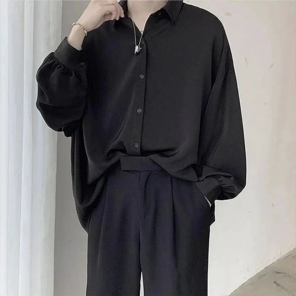 Korean-style men's oversized black button-down shirt with voluminous puff sleeves and relaxed fit.