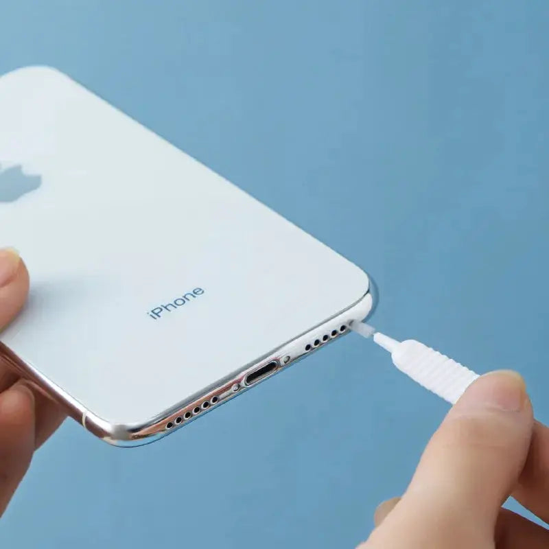 Micro nylon shower cleaning brush nozzle; white compact cleaning tool shown cleaning an iPhone charging port