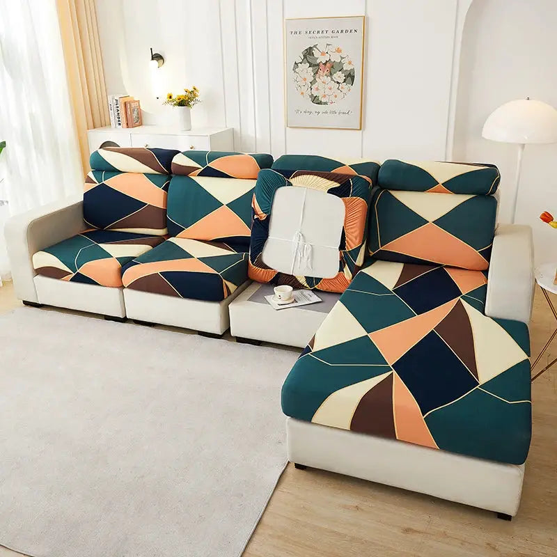 Simples Market L-shaped sofa slipcovers in teal, peach, cream and brown geometric pattern.
