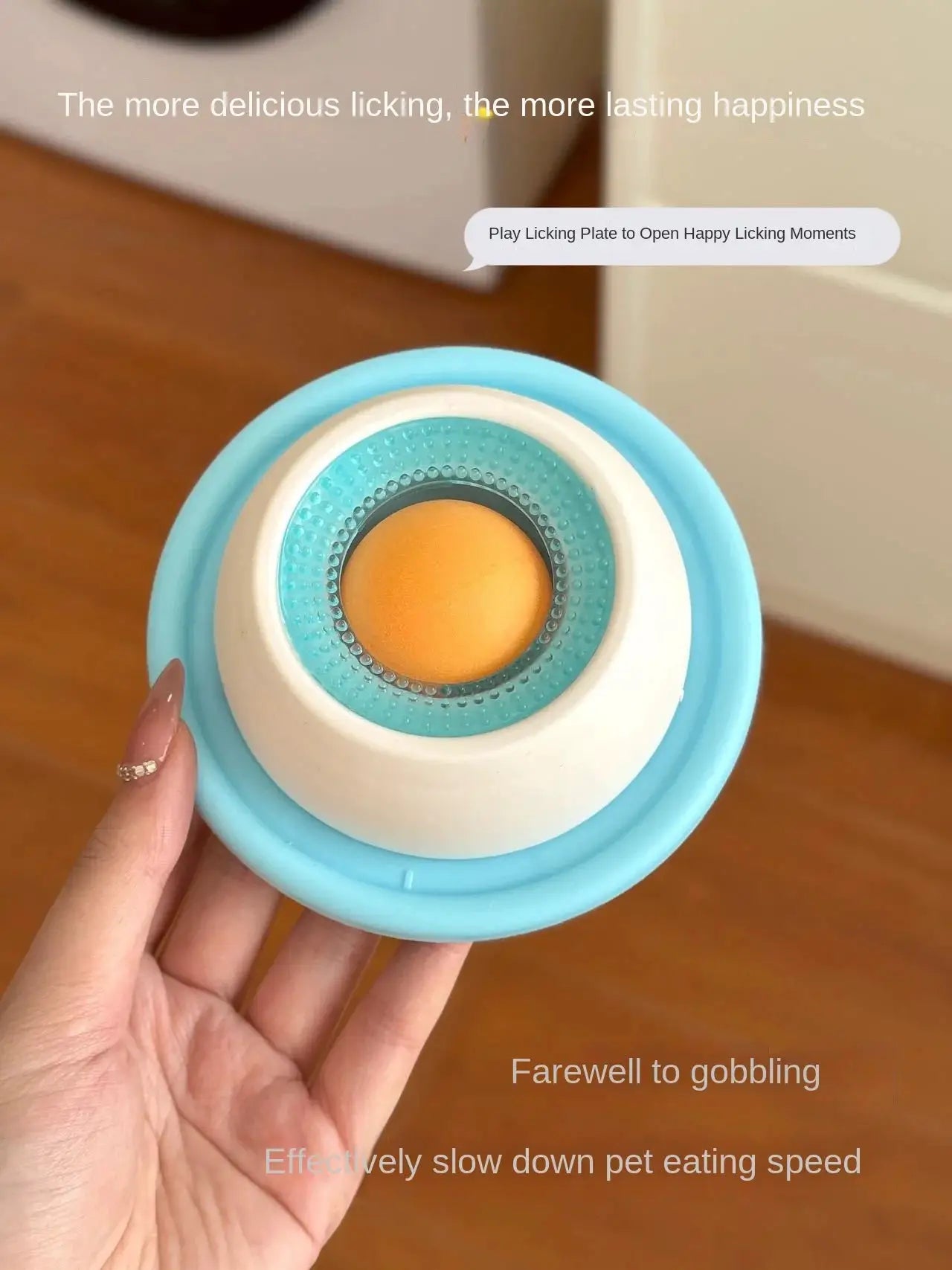 Lick toy for dogs, interactive slow-feeder with blue outer ring, white center, orange ball