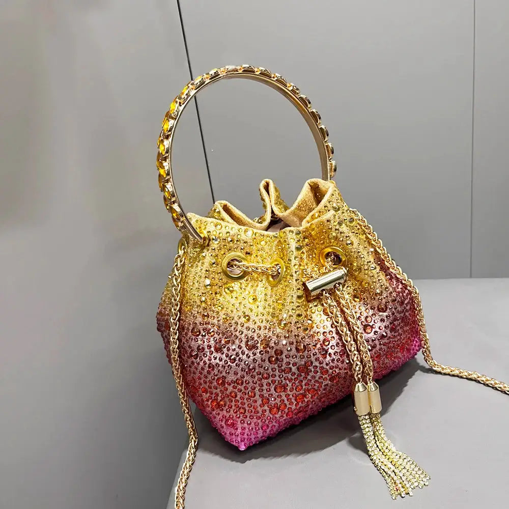 Simples Market rhinestone evening clutch with gradient gold-to-pink crystals, ring handle and gold chain