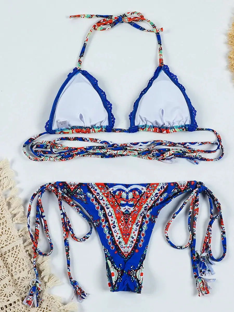 Two-piece bikini set by Simples Market white triangle top with blue lace trim and tie straps, patterned side-tie bottom.