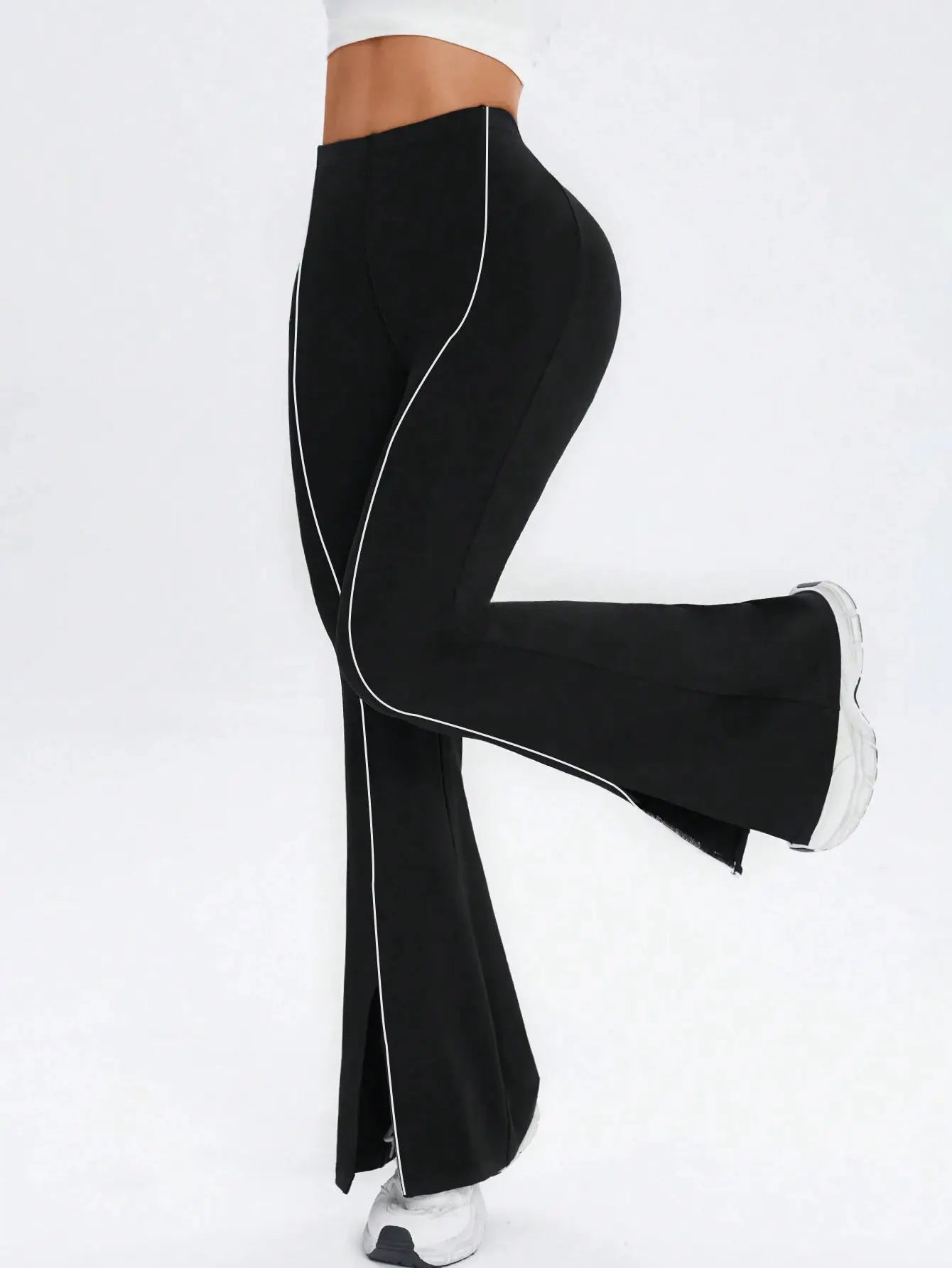 Women's high-waist black flared yoga pants with white piping, athletic wide-leg fitness leggings