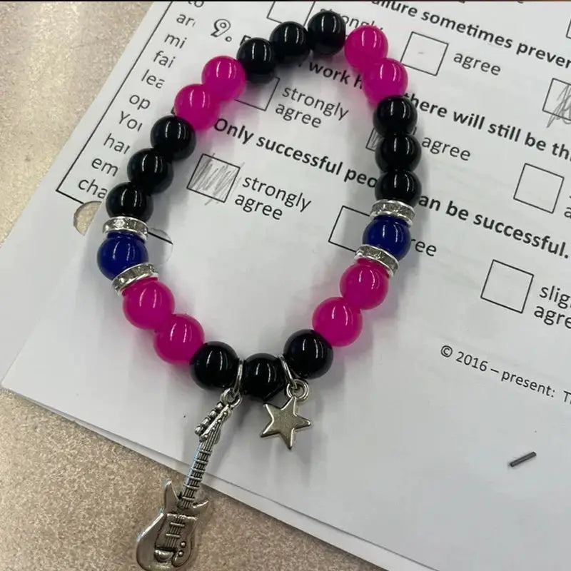 2-piece Simples Market bead bracelet set for couples, pink and black beads with blue accents, guitar and star charms