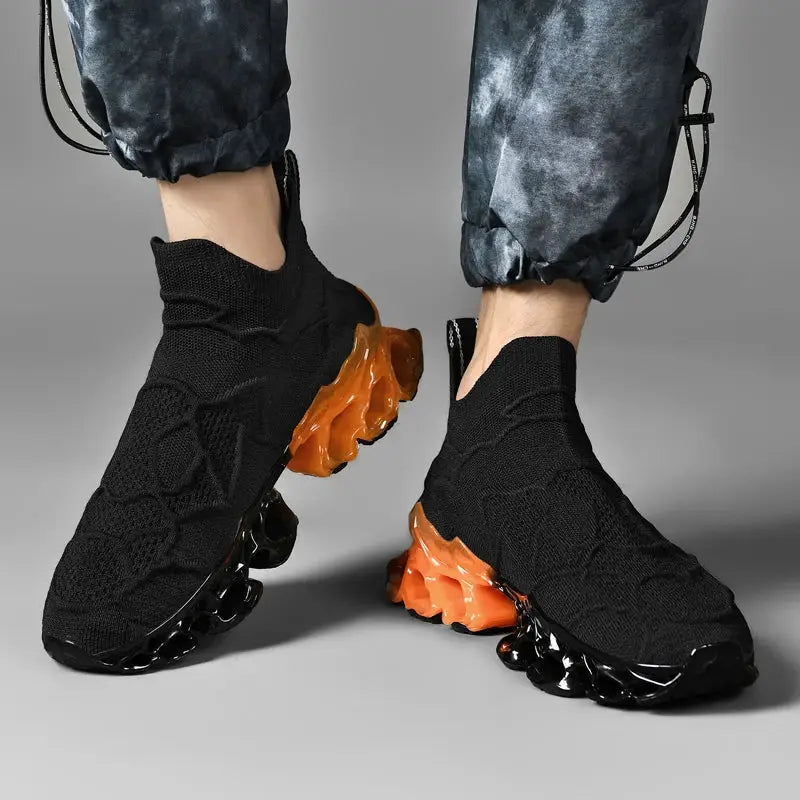 Men's black knit sneakers with orange translucent chunky outsole; casual breathable trainer pair