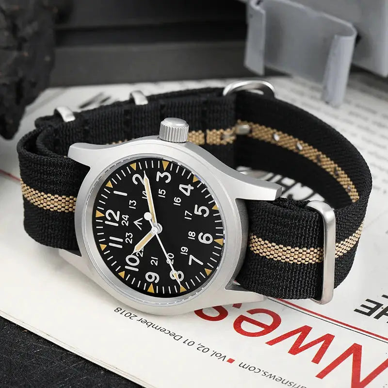 Militado ML05 vintage field watch with black dial, luminous hands, 24-hour markers, silver case, black-tan NATO strap