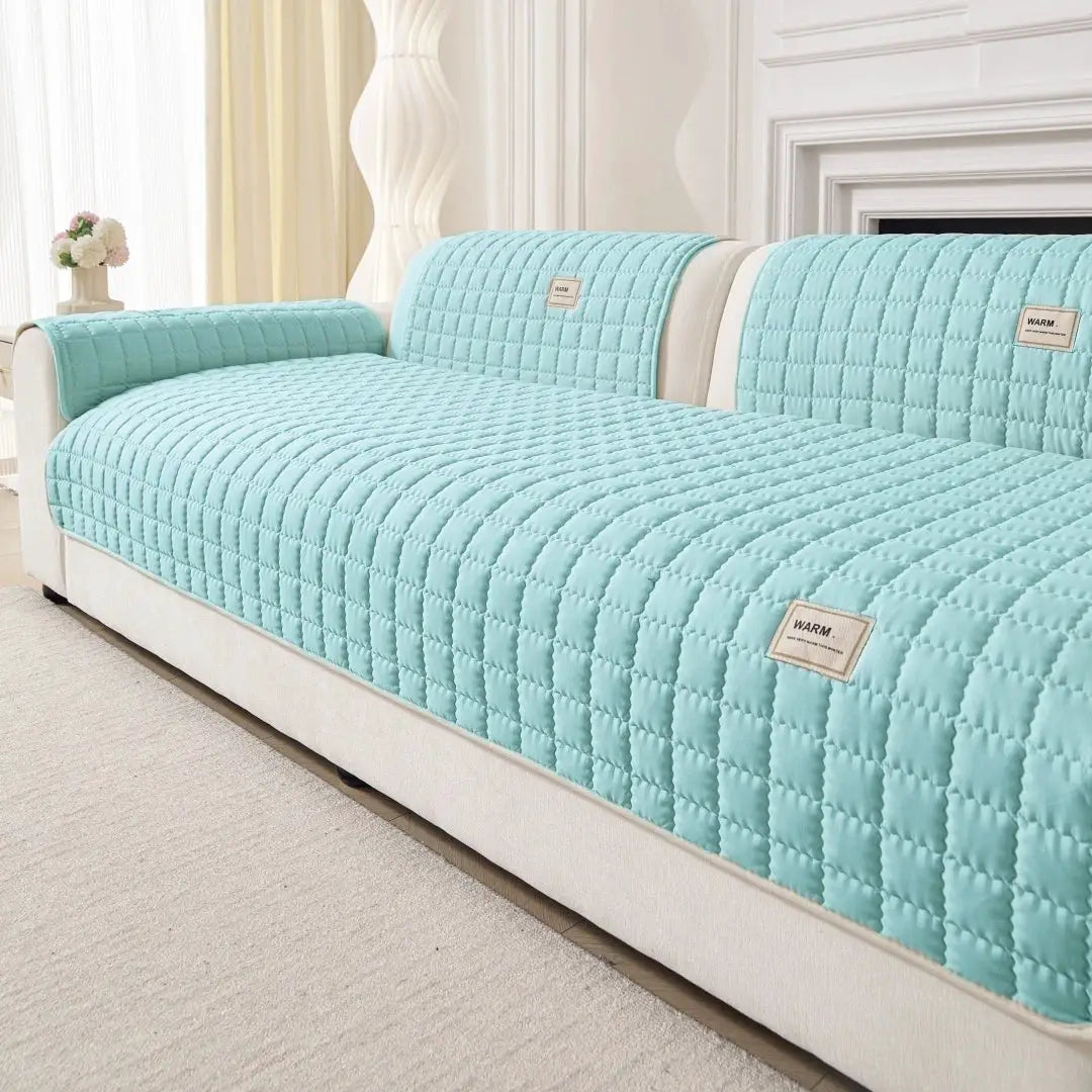 Sofa cover Simples Market turquoise quilted anti-slip on beige sofa with armrest protection