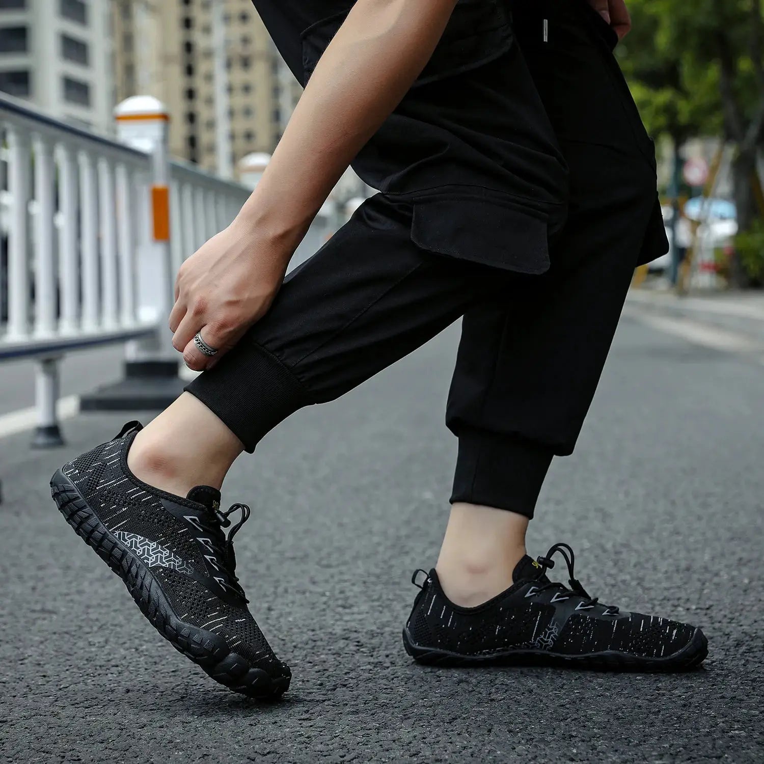 Men's trail running shoes in black with knit upper and rugged outsole