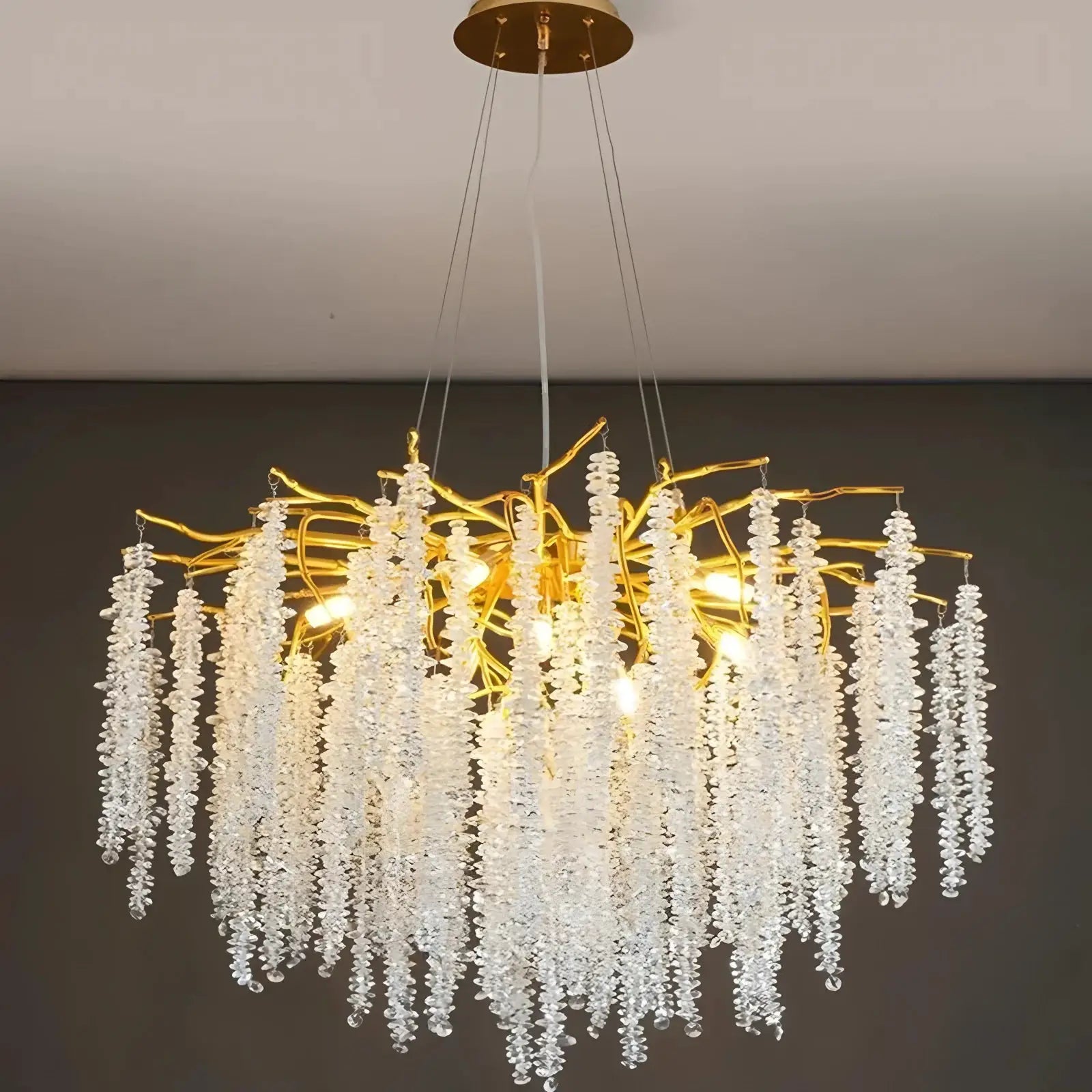 Modern crystal chandelier with gold branches and hanging crystal drops by Simples Market