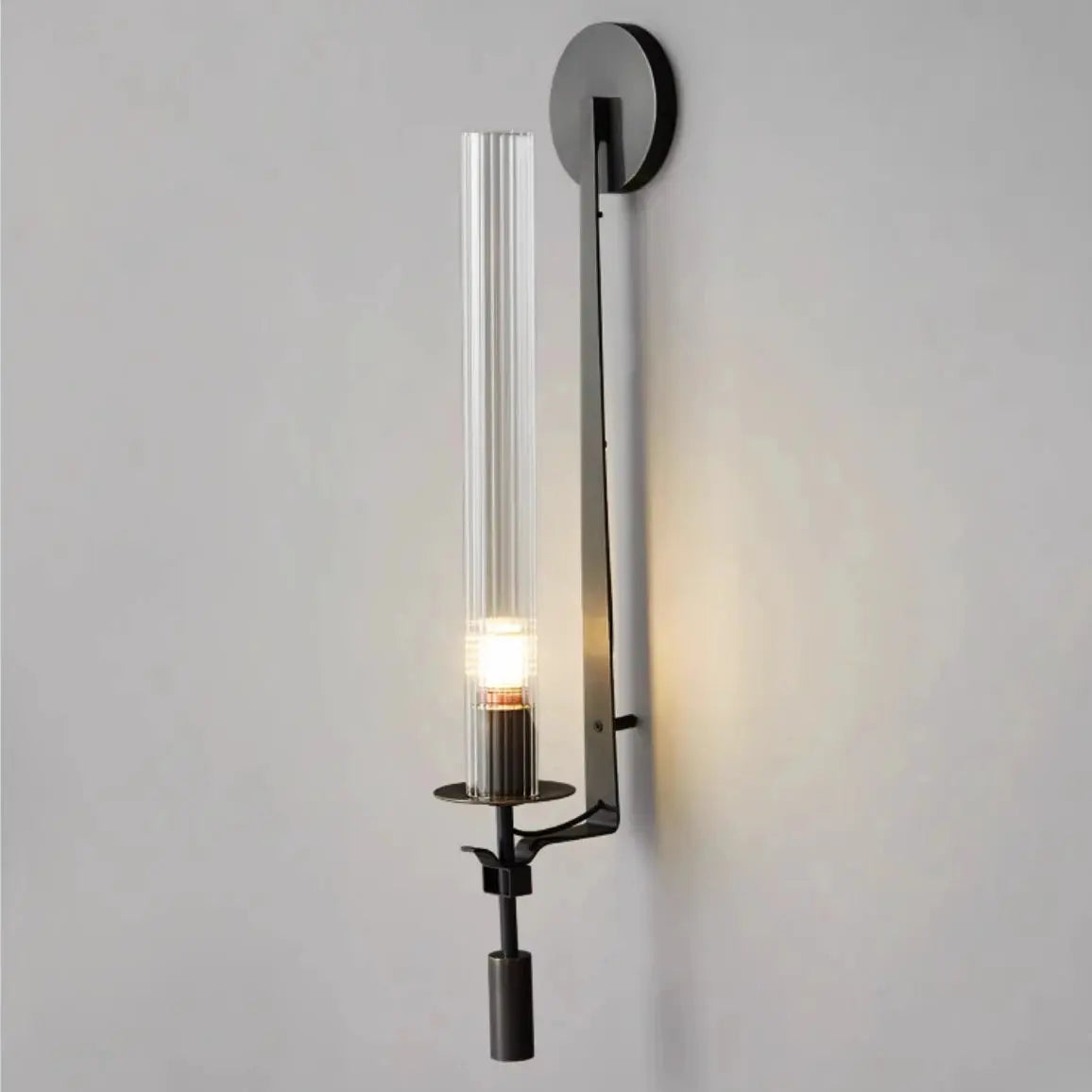 Modern copper wall sconce with clear ribbed glass column and dark metal backplate, wall-mounted lighting.