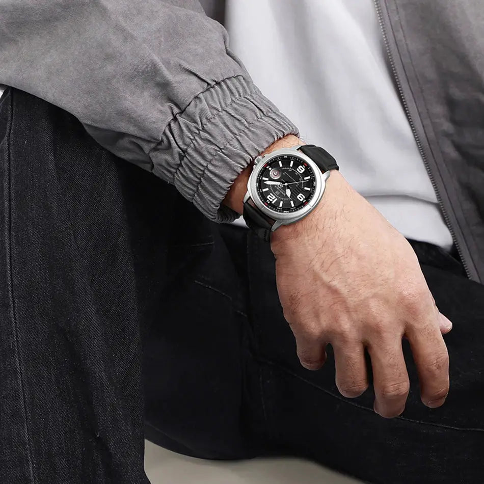 NAVIFORCE men's quartz watch with black dial, silver case, and black PU strap on a man's wrist; calendar date display.
