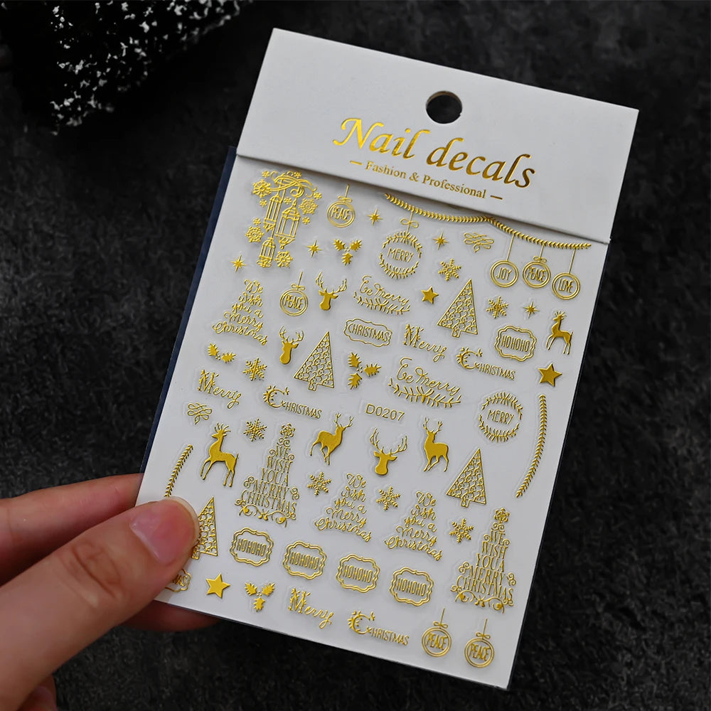 Nail decals sheet in gold with Christmas motifs like reindeer, trees, snowflakes, Merry Christmas by Simples Market