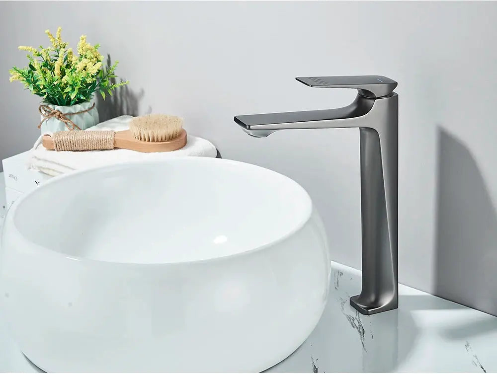 Deck-mounted single-lever bathroom faucet in brushed metal finish with a tall modern silhouette