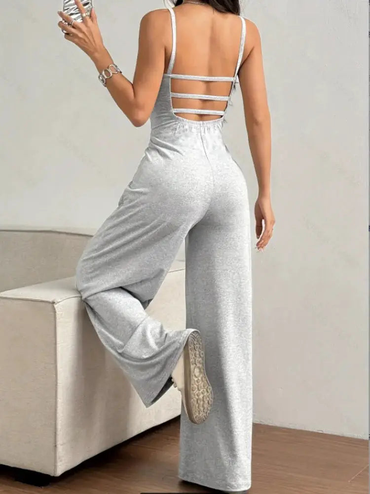 Women's halter backless jumpsuit in light gray; sleeveless, wide-leg, floor-length.