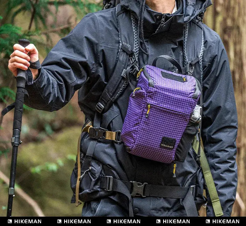 Outdoor luggage strap with adjustable plug-in buckle; worn by hiker with purple grid-pattern Hikeman pack.