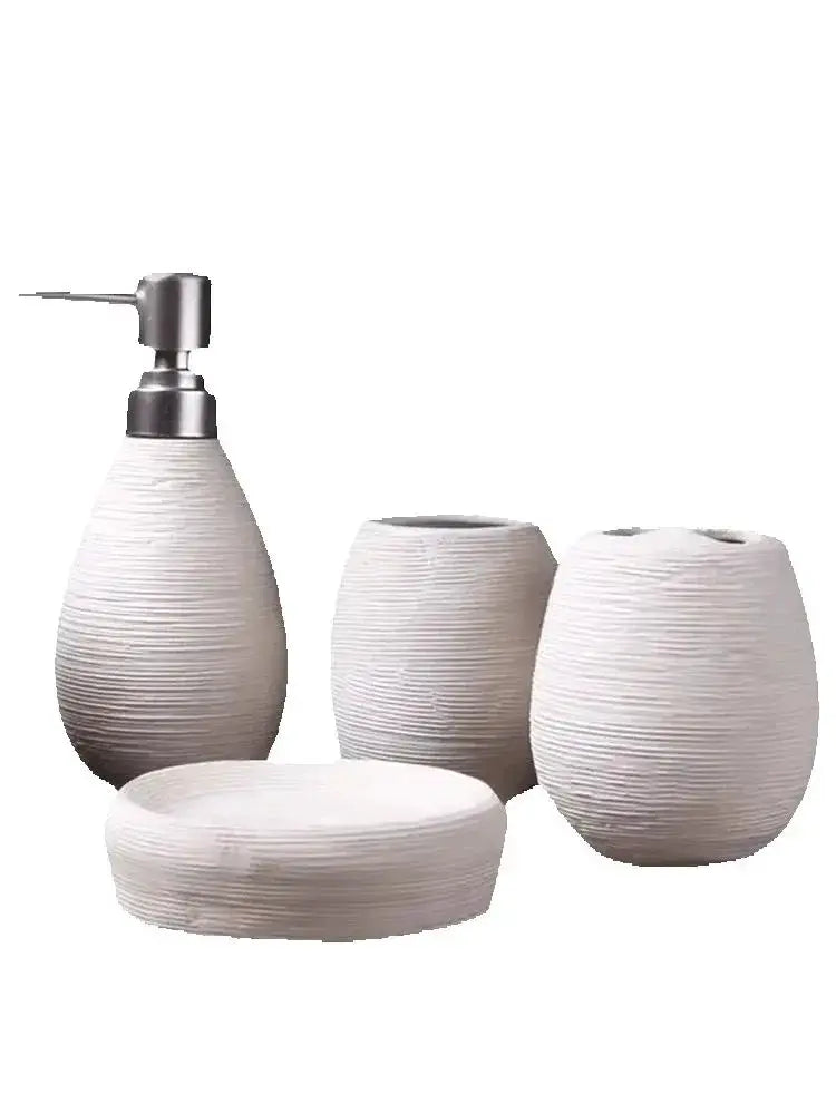 Simples Market bathroom ceramic set with white textured pump dispenser, two toothbrush holders and soap dish.