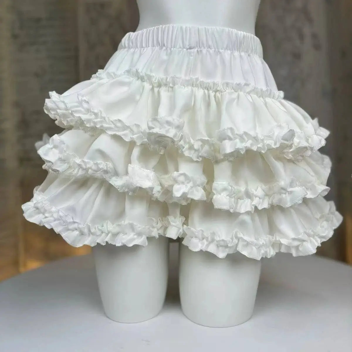 White Lolita-style cake skirt with layered ruffles and lace trim, mini kawaii party skirt