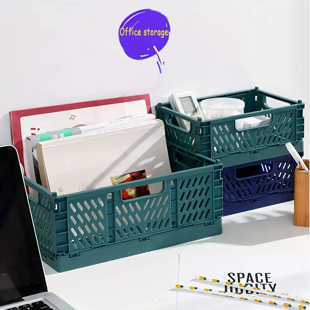 Two teal plastic foldable storage crates, stackable with lattice sides, holding magazines and office supplies.