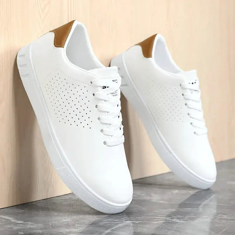 Men's white leather sneakers with perforated sides, tan heel patch, lace-up.