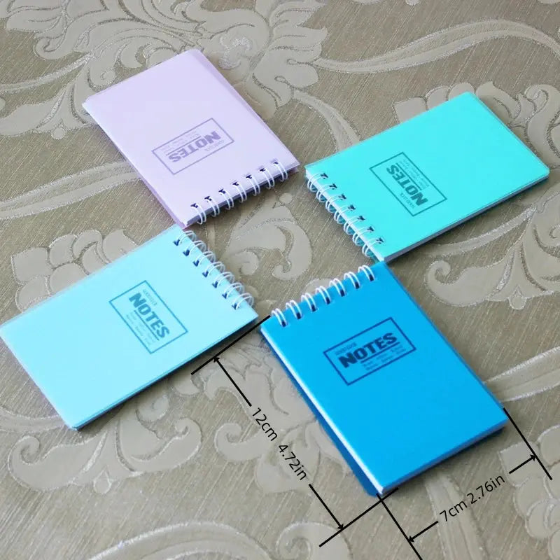 5 mini pocket note pads in pastel purple and blue with spiral binding; each 7×12 cm, NOTES stamped on covers.
