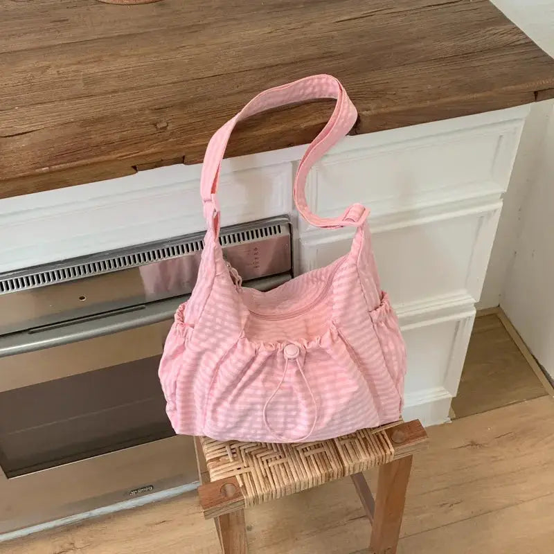 Pink plaid nylon shoulder bag with drawstring closure, ruched sides, crossbody tote