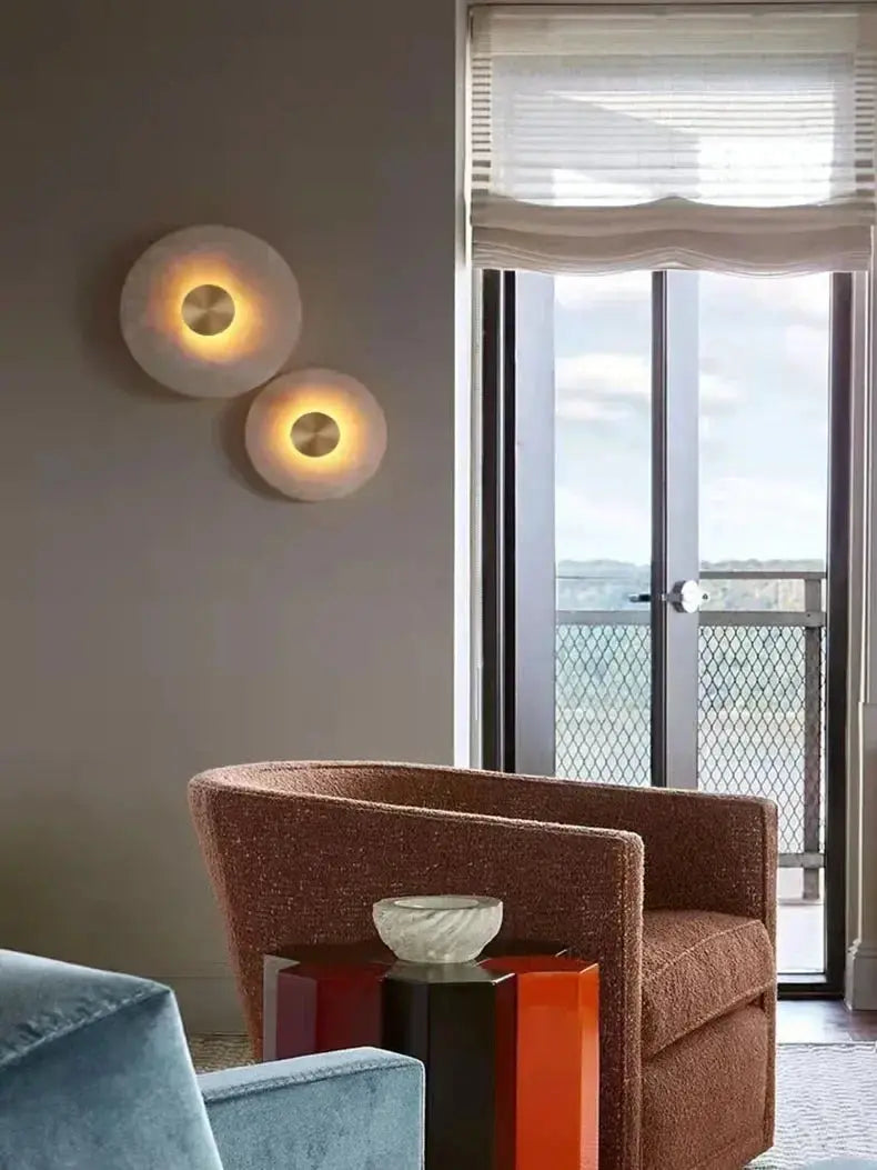 Pair of round marble wall lamps with copper center glow and warm LED lighting
