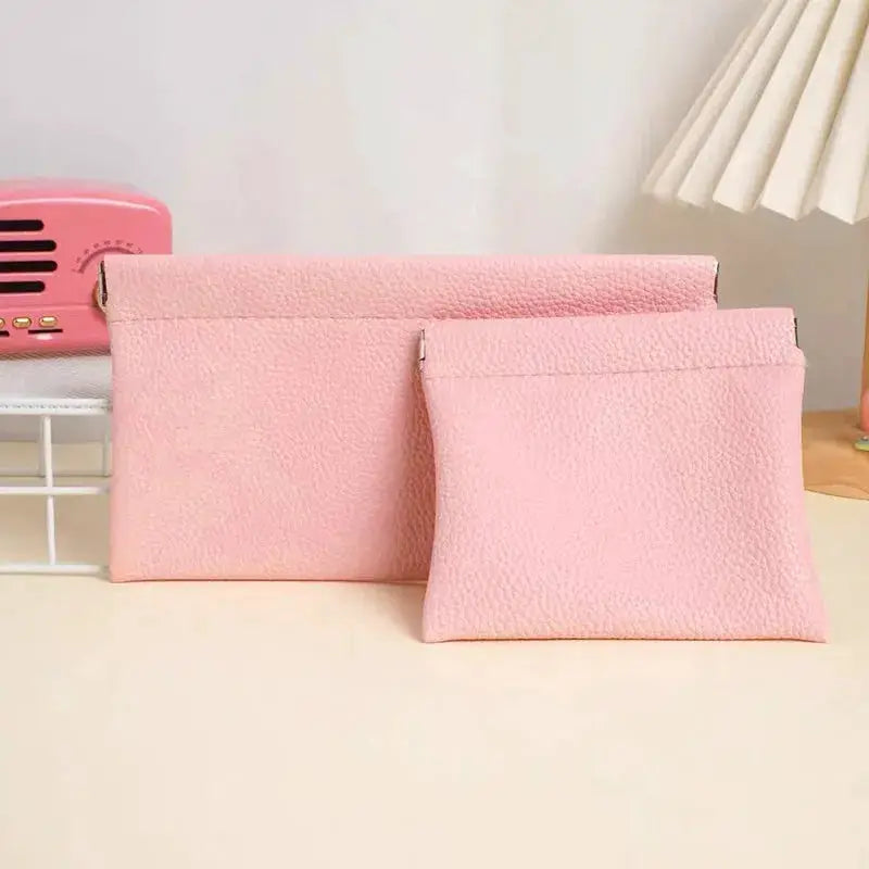 Self-closing pink artificial-leather long wallet and small matching pouch (2-piece set) on desk