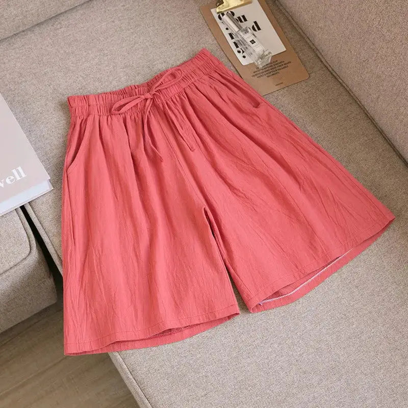 Women's pink cotton shorts by Simples Market with high waist, drawstring, and two pockets.
