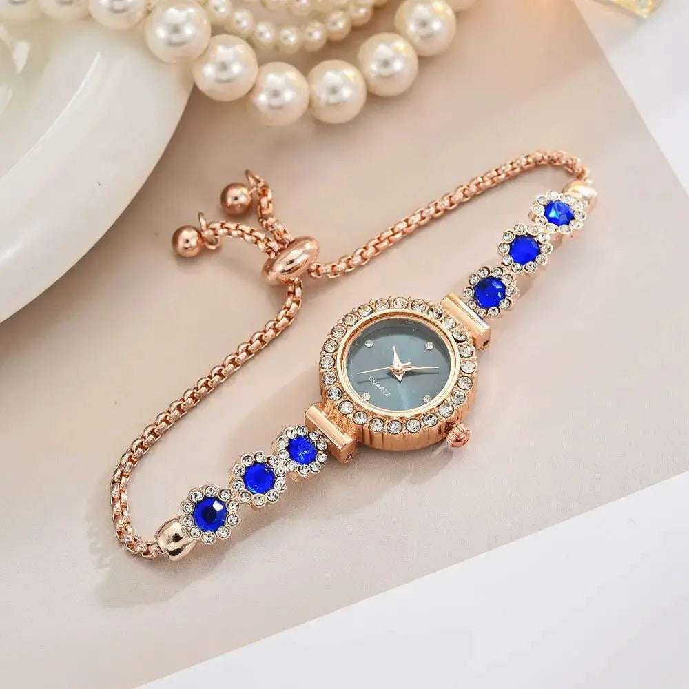 Rose gold rhinestone women's wristwatch with blue crystal bracelet links and crystal halo bezel.