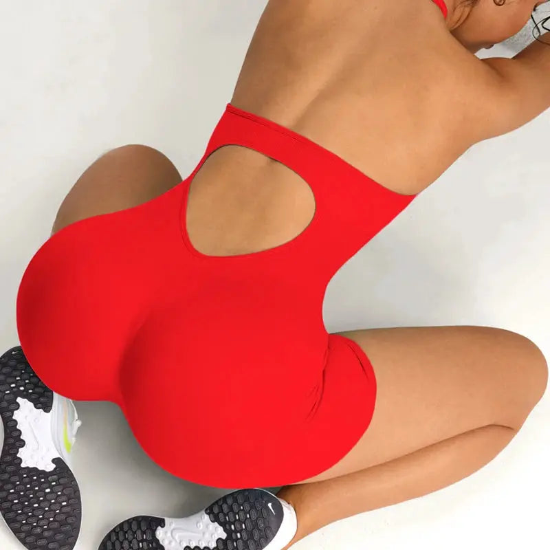 Women's red gym romper jumpsuit with back cutout for yoga and workouts