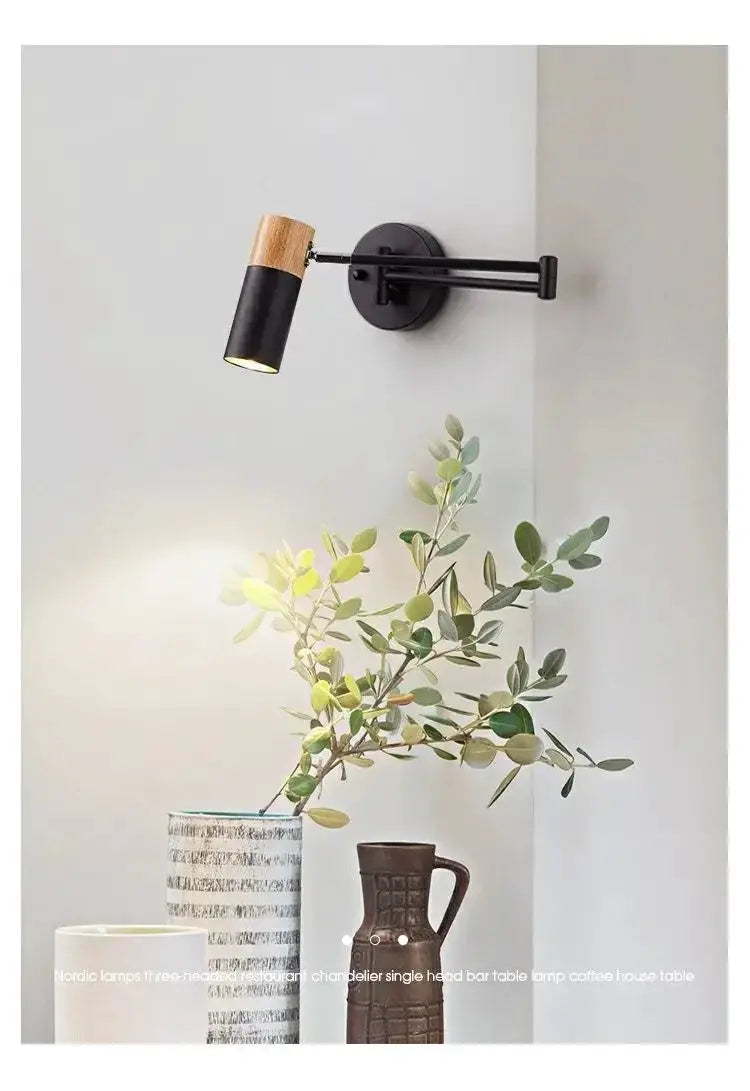 Wall lamp with black metal arm and wood-accented head by Simples Market