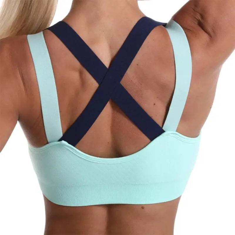 Cross-back sports bra, color-blocked light aqua with navy crisscross straps