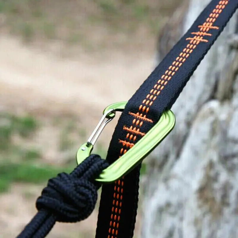 Two black polyester hammock straps with orange stitching and lime-green carabiner hardware