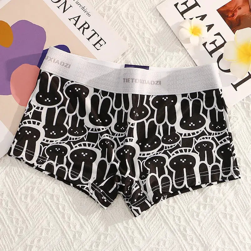Women's seamless boyshorts underwear by Simples Market in black with white bunny print and gray branded waistband.