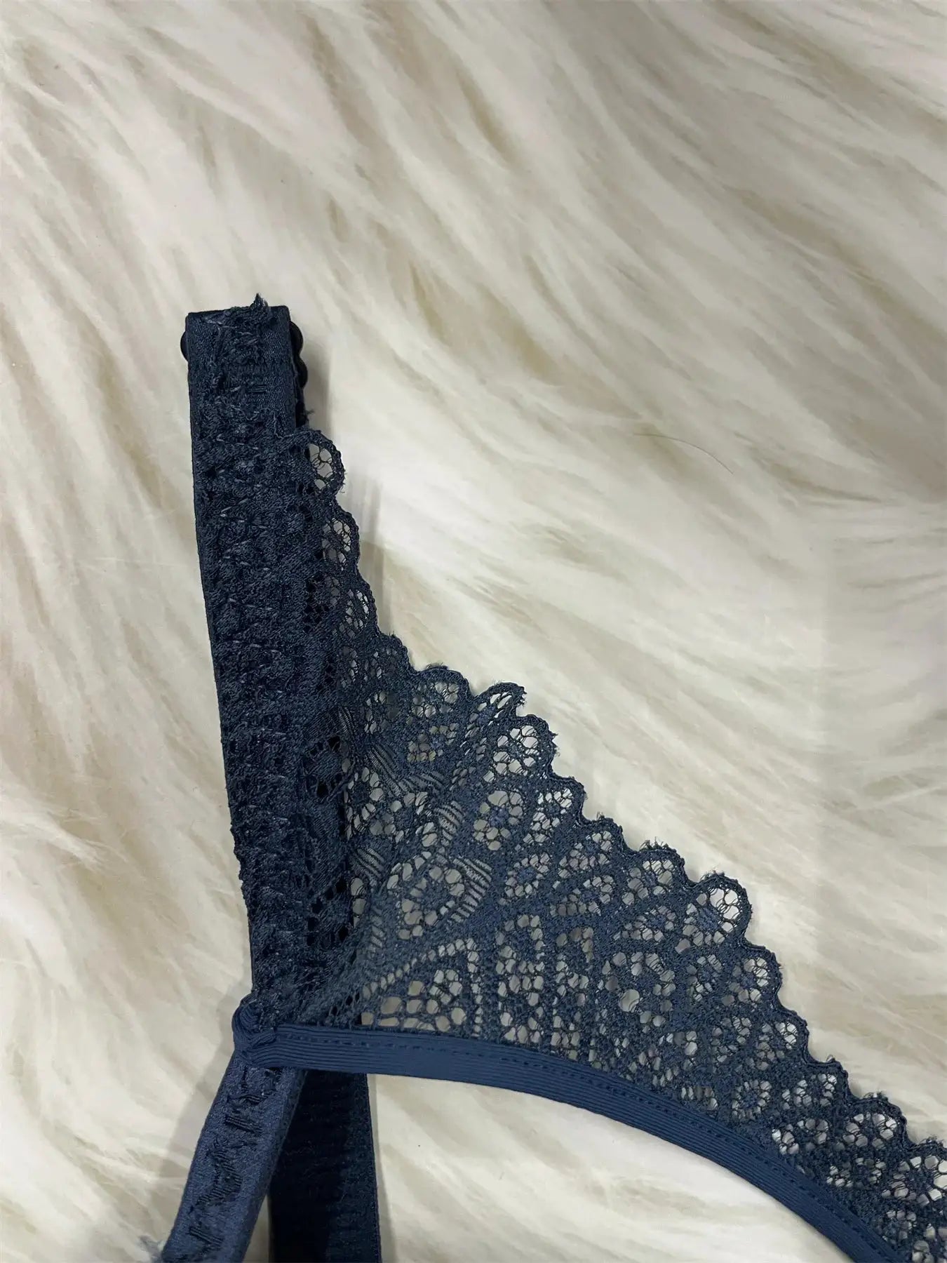 Navy blue lace underwire bra with scalloped edges and wide band