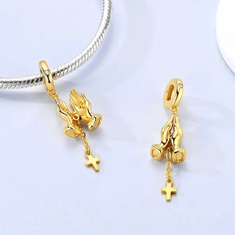 Two gold-tone praying hands charms with cross pendants and small crystal accents on the loops, for DIY bracelets