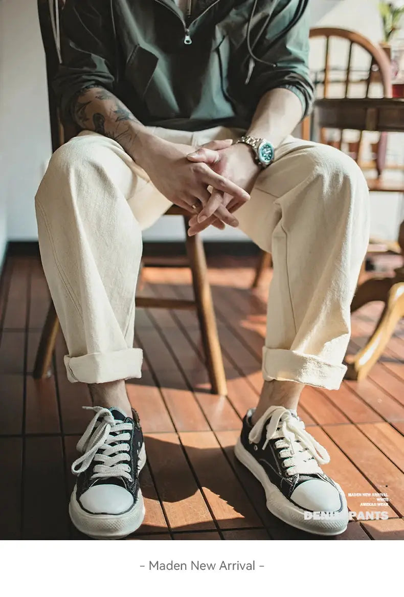 Maden Vintage white cottonseed hull jeans for men, loose straight fit with rolled cuffs, paired with black sneakers