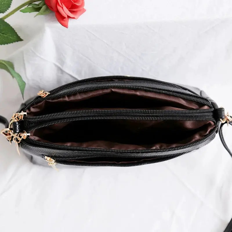 PU synthetic leather women's shoulder crossbody bag in black with brown interior lining