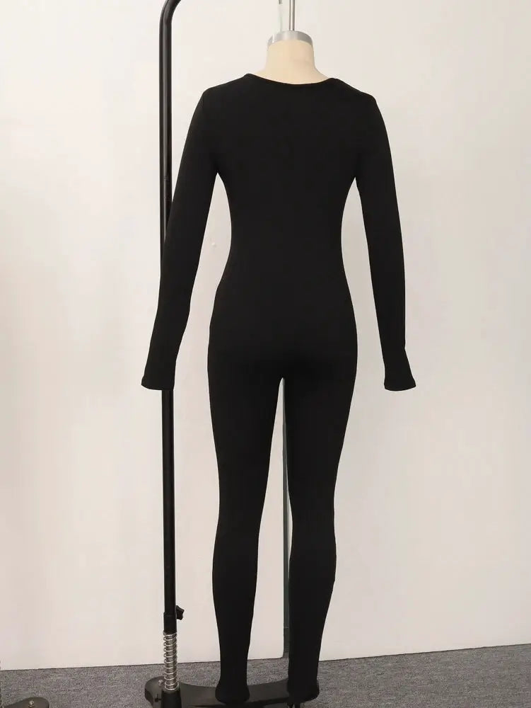 Women's long-sleeve skinny jumpsuit in black, pullover style, on mannequin.