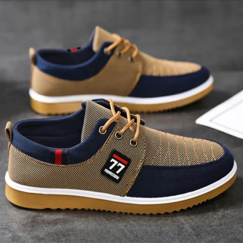 Pair of men's knitted casual sneakers in tan and navy with a white midsole