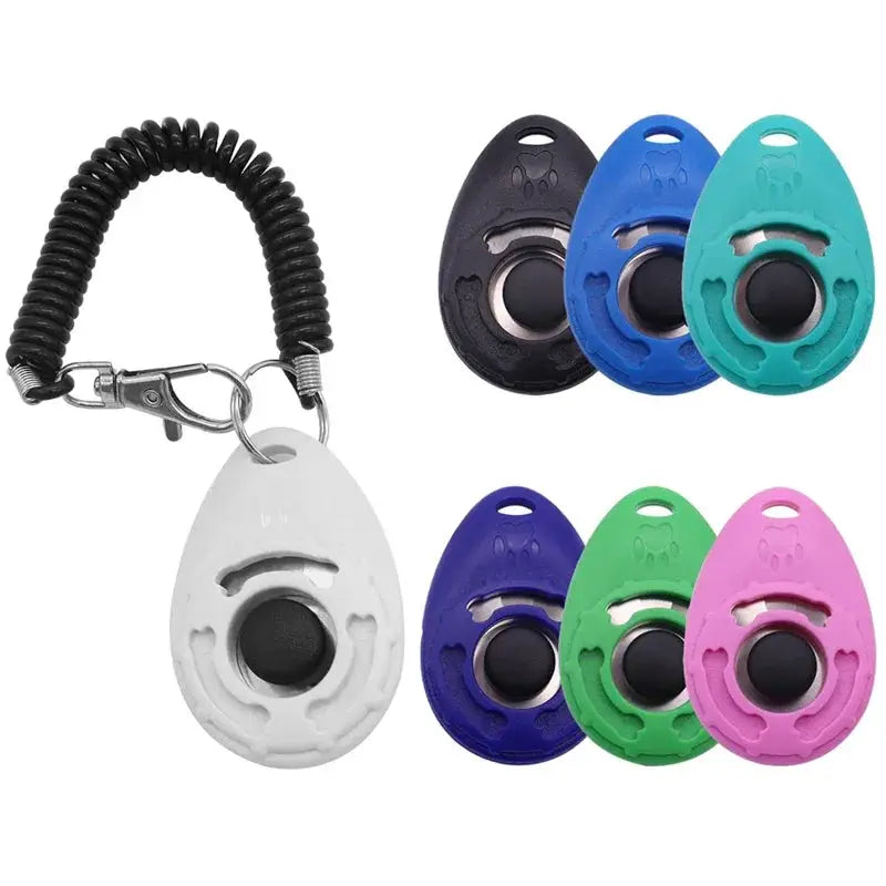 Adjustable dog training clicker with wrist strap and keychain; white clicker with black button among seven color variants.