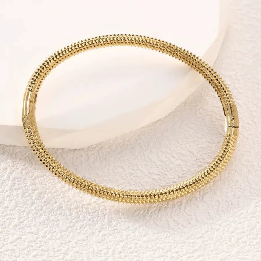 ZAKOL gold stainless steel cuff bracelet for women with textured studded surface