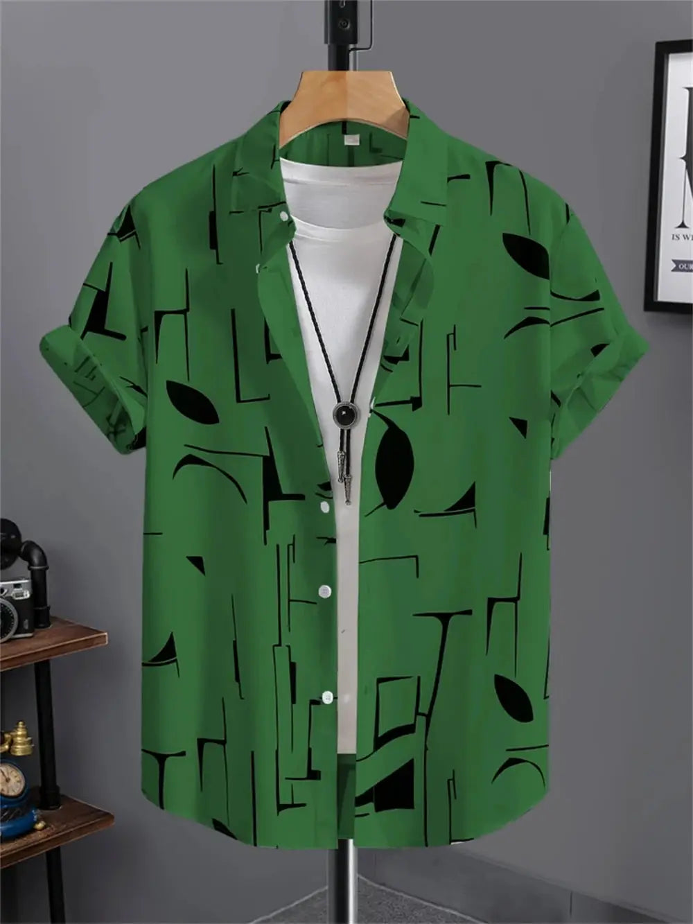 Simple men's green short-sleeve button-down shirt with black abstract geometric print