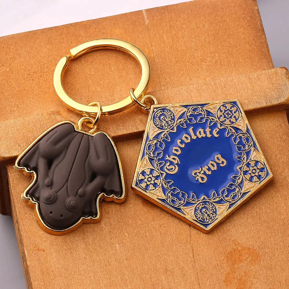 2-piece Chocolate Frog keychain set with black frog charm and ornate blue-gold hex charm