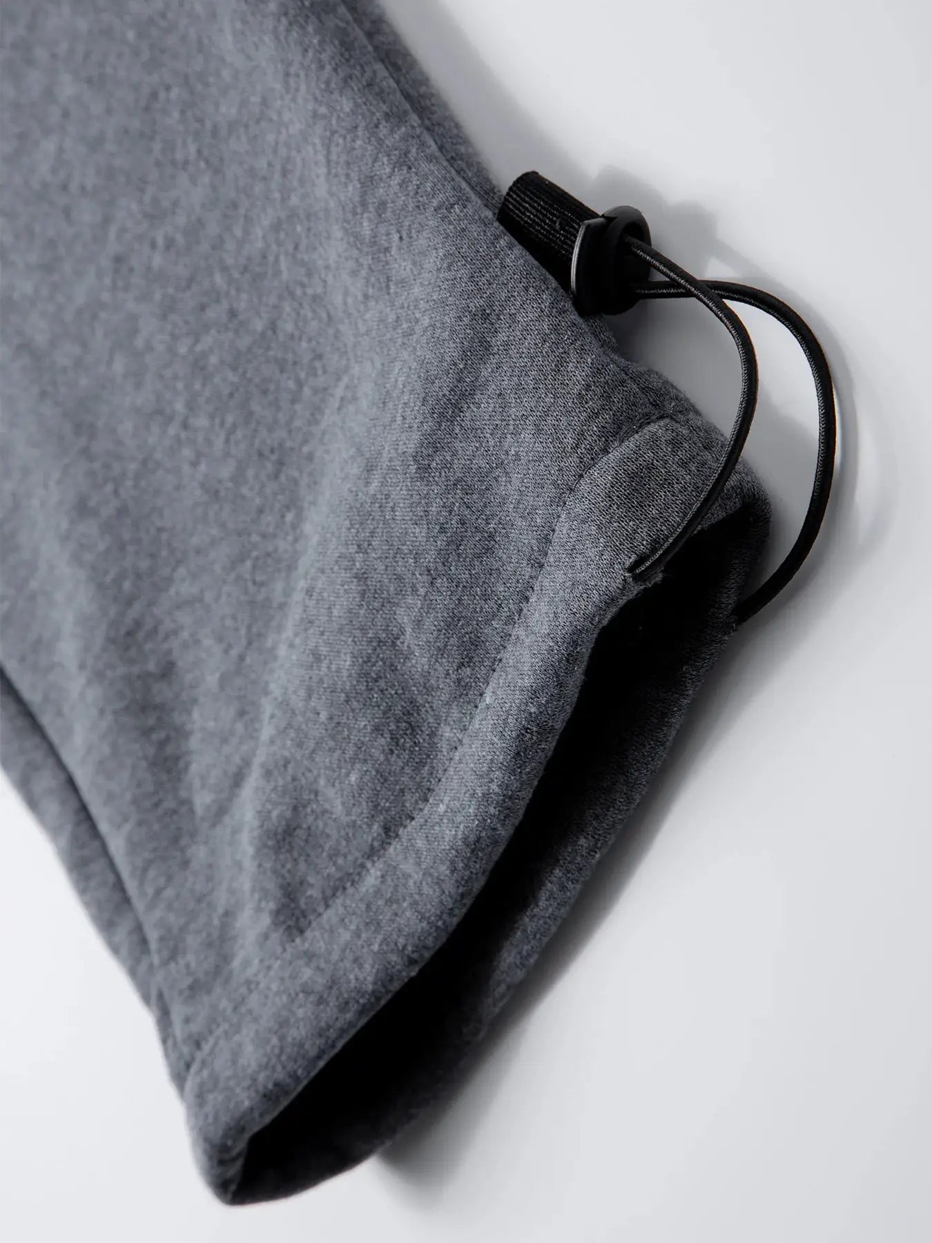 Men's grey joggers with drawstring waist and cord lock on heather fabric