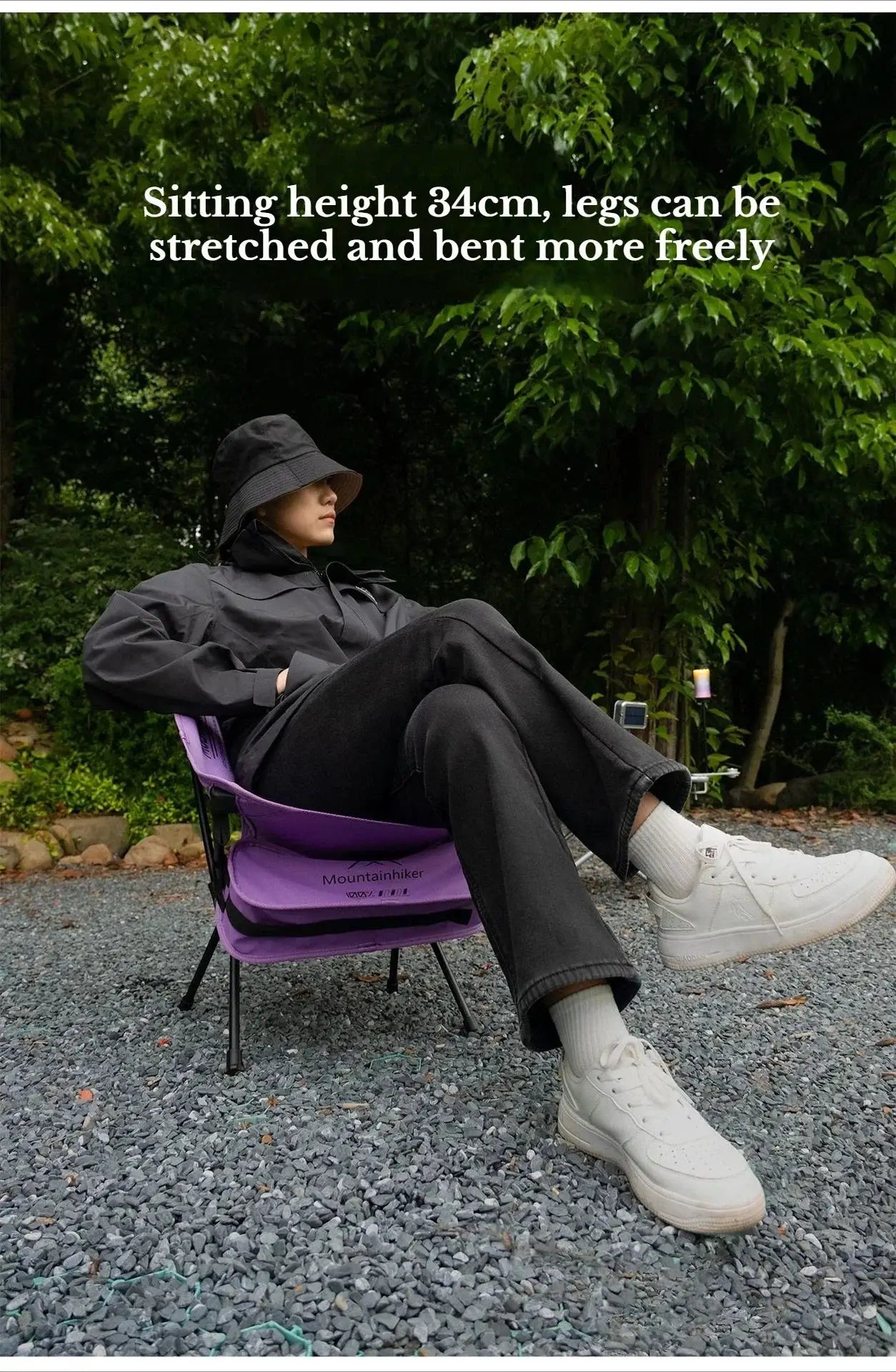 Purple Mountainhiker foldable camping chair; person lounging outdoors in a garden setting.