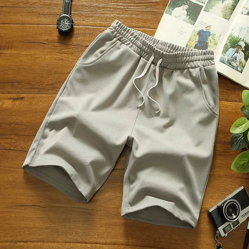 Men's grey mesh shorts with drawstring waistband and side pockets, quick-dry gym shorts.